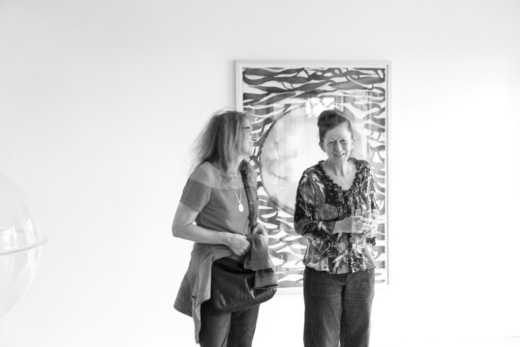 Ingrid Roscheck speaks to a visitor of the exhibition