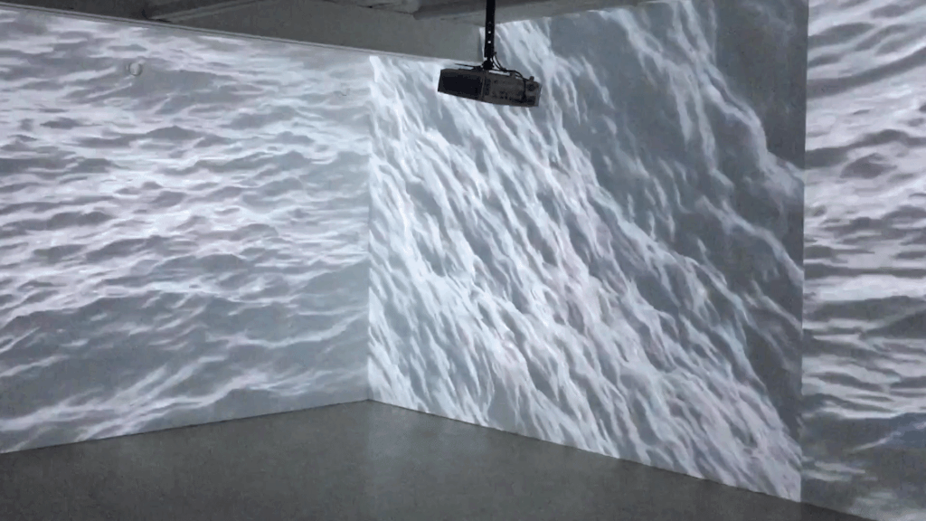 Video installation with waves on wall, with inscription "losing Days- Covid-19