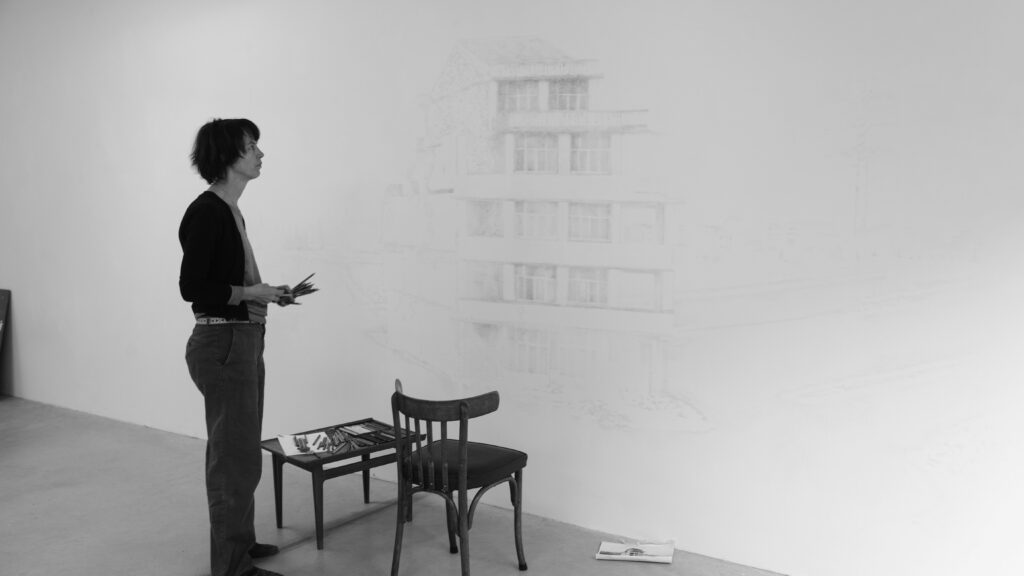 black and white photo, artist Marianne Halter exhibition view with diagonally placed box in the room, corner wall, wall drawing