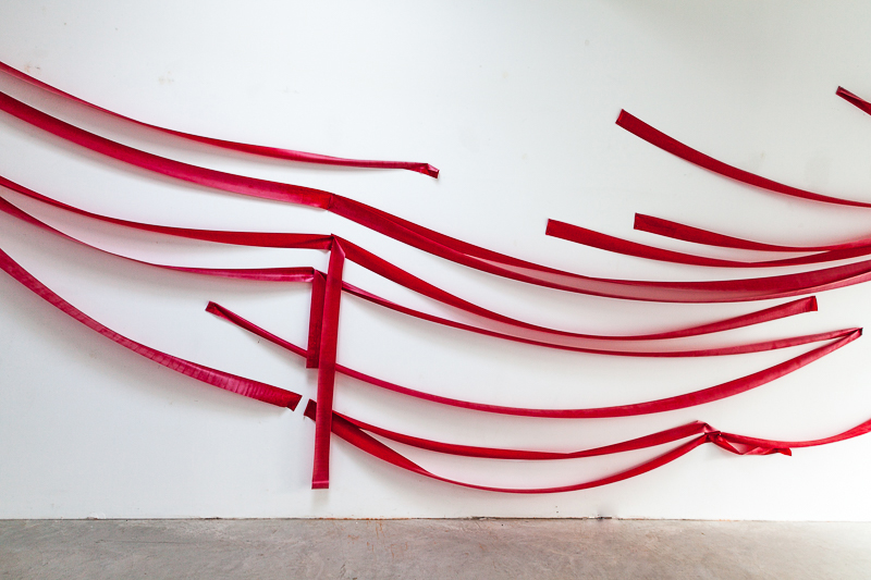 Red rubber bands on the wall